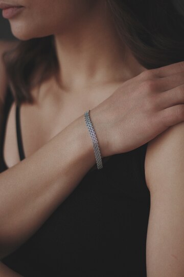 women wearing silver bracelet